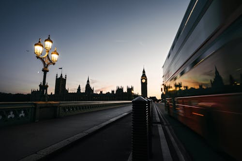 Double-Decker Bus Riding on Westminster Bridge in London at Dusk