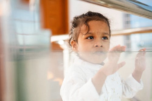 Little Girl Looking Out the Window