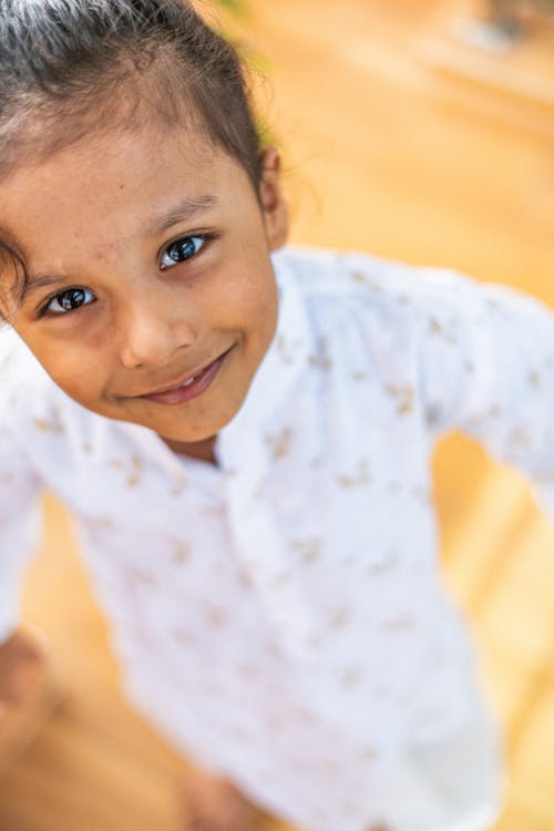 Portrait of a Little Brunette Girl in White Pajamas