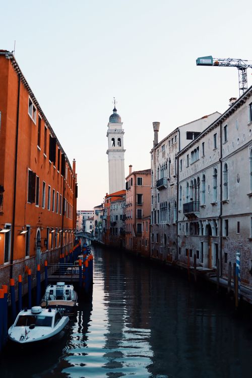 Free Explore Venice's charming canals and historic architecture as the sun sets over this iconic skyline. Stock Photo