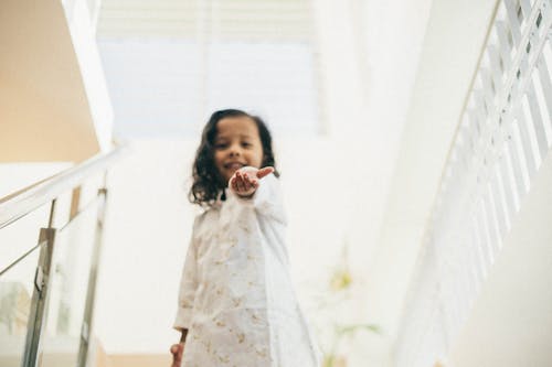 Cute Little Girl Standing on Stairs