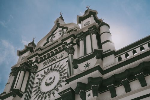 Free Stunning view of an intricately designed mosque facade with crescent symbols and geometric patterns. Stock Photo