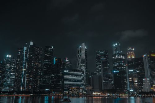 Free Dramatic view of Singapore's illuminated cityscape at night featuring iconic skyscrapers. Stock Photo