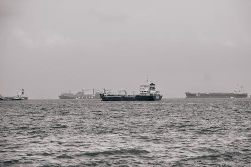 A black and white photo of a ship in the ocean