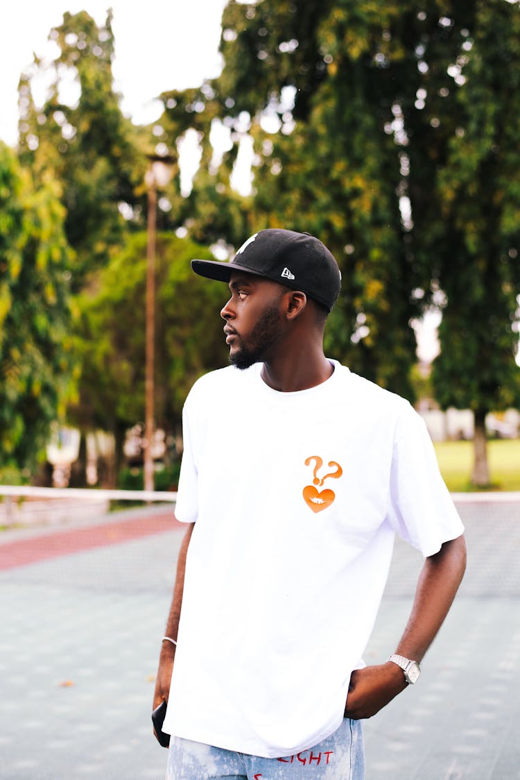 Young Man In A Casual Outfit Standing Outside 