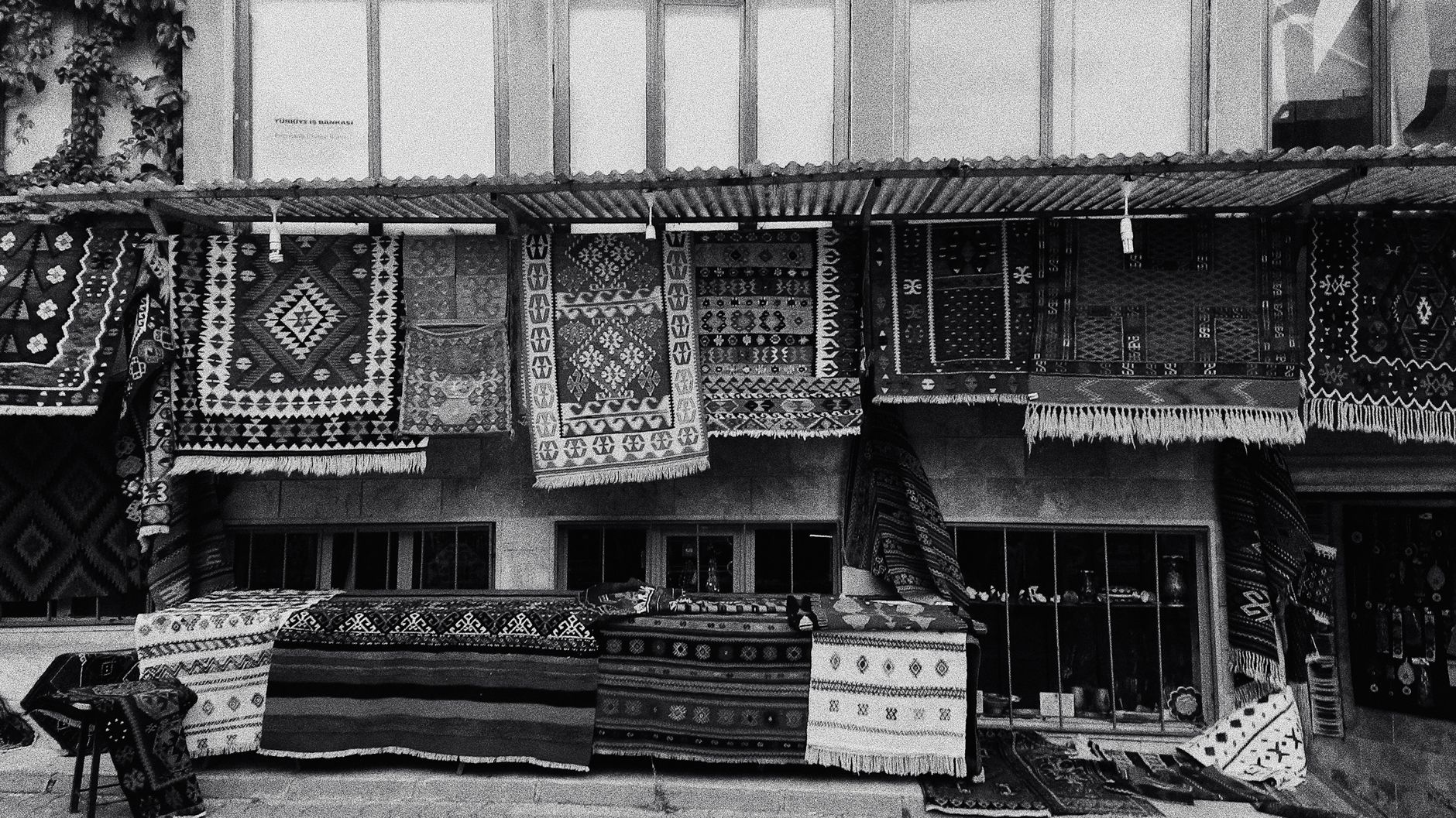 Artistic black and white photo of a traditional rug market in Ankara, Türkiye.