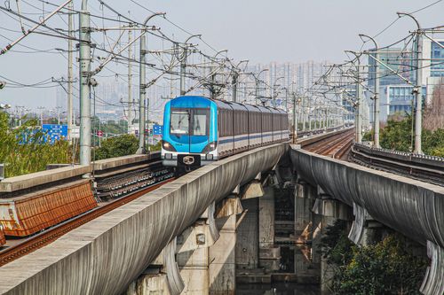 Free A modern train travels on an elevated railway through the urban landscape of Shanghai, China. Stock Photo