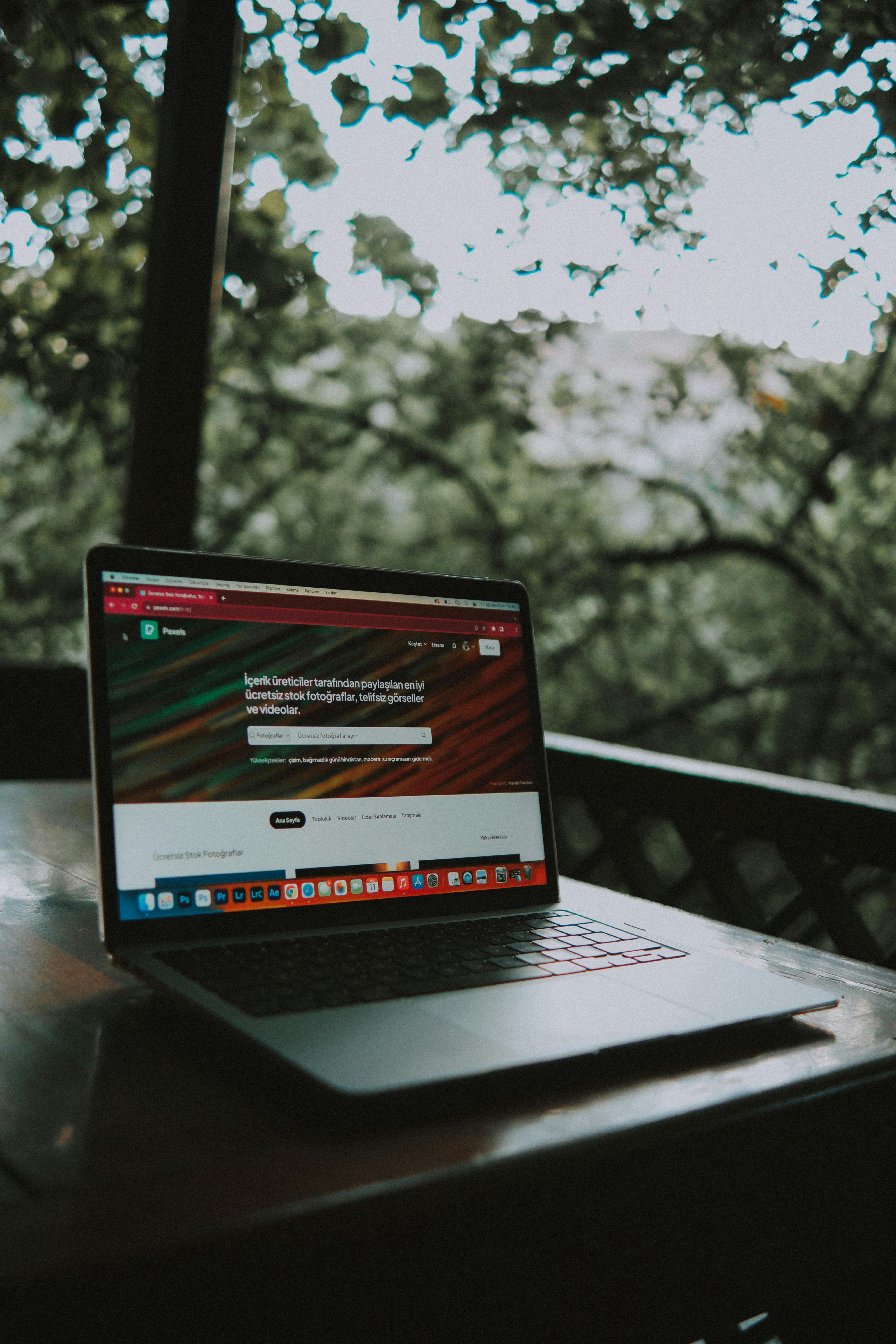 website displayed on a laptop standing on a wooden table