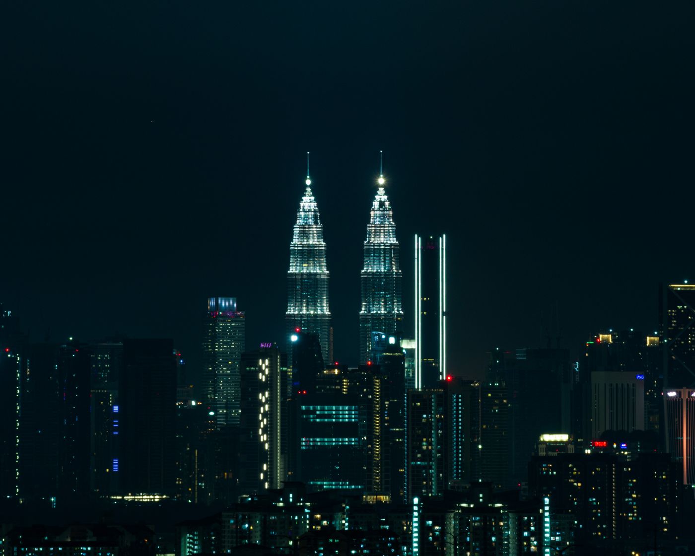 Petronas Towers illuminated at night in Kuala Lumpur