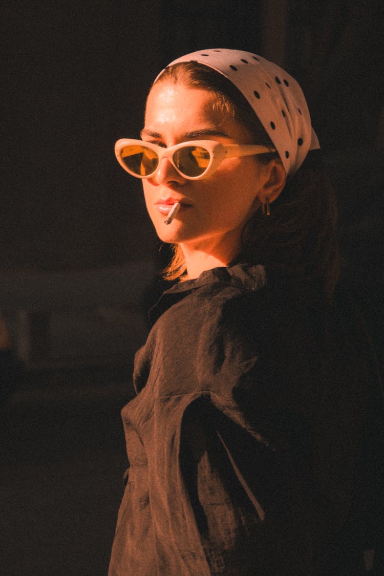 Woman Posing In Black Shirt, Headscarf And Vintage Sunglasses