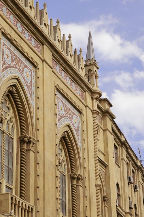 Free An intricate architectural facade with ornate details and Gothic influences. Stock Photo