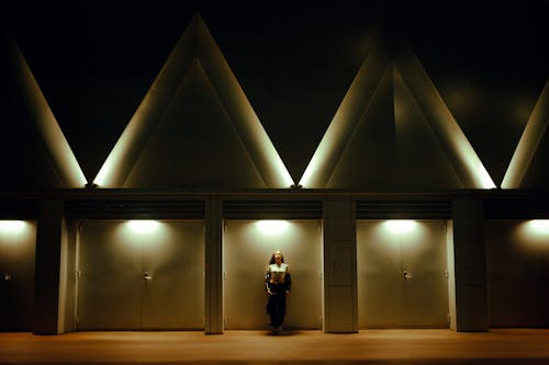 Woman Standing in an Illuminated Building