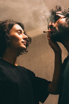 A couple shares a moment indoors, capturing intimacy and relaxation. - Fotografer Sidoarjo