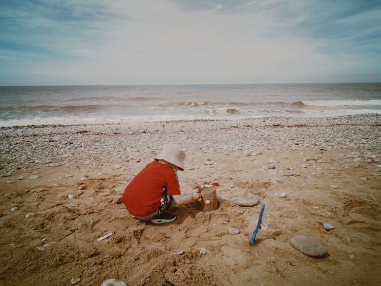 A Child Building A Sand Castle 