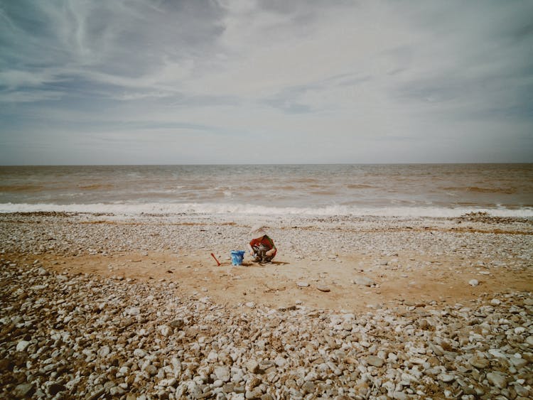 A Child Building A Sand Castle 