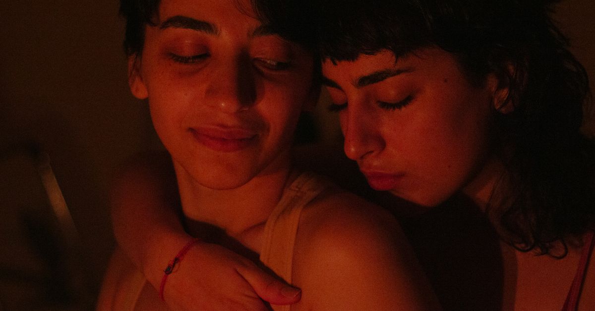 A warm, intimate embrace between two women, capturing a moment of affection and connection.