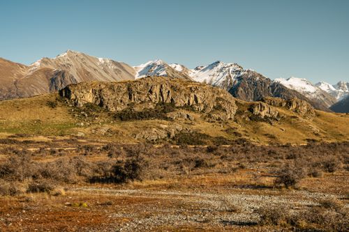 Free Breathtaking view of sunlit mountains and rocky landscape in Canterbury, New Zealand. Stock Photo