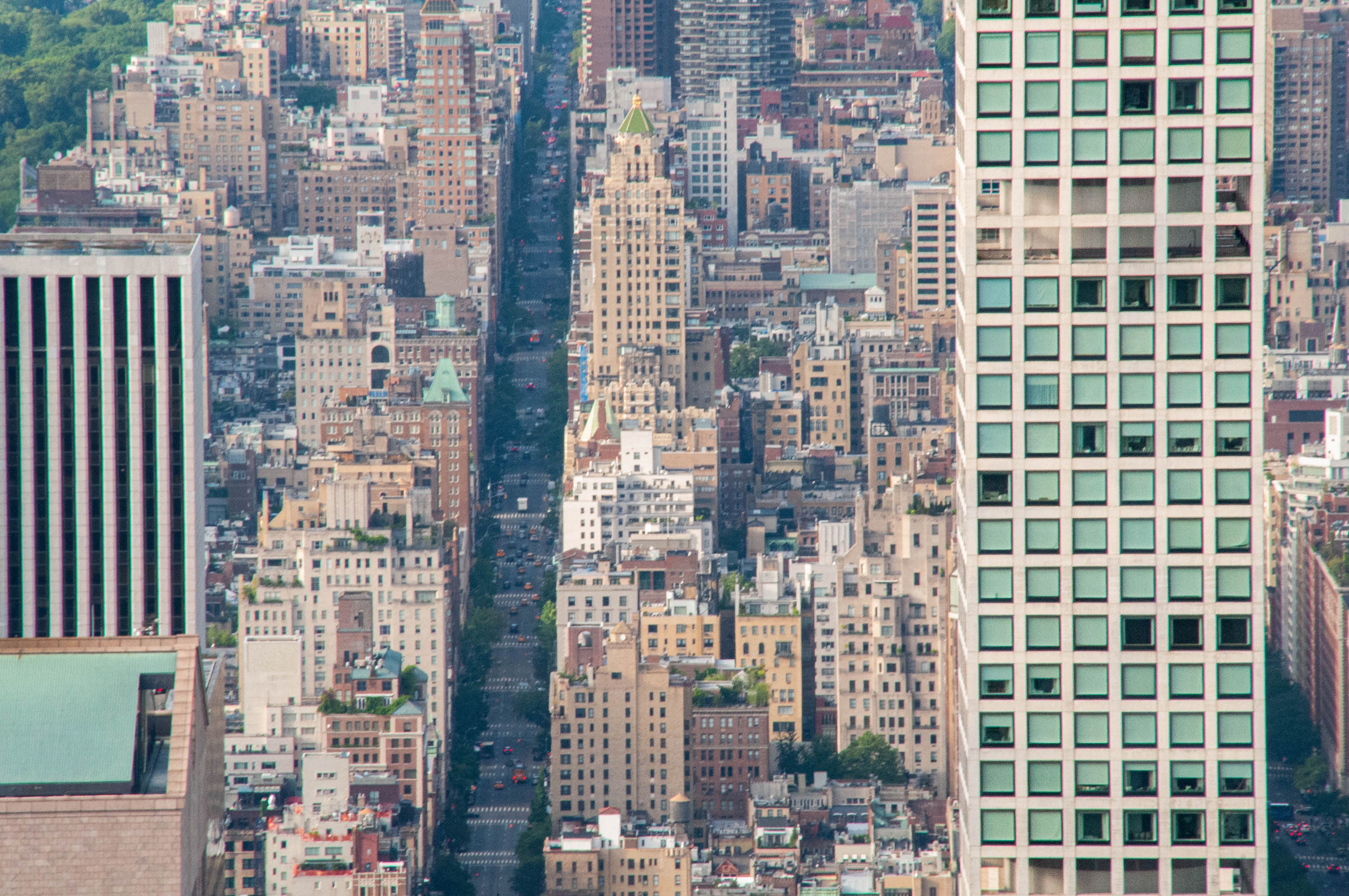 Aerial perspective of Manhattan's bustling cityscape featuring dense skyscrapers.