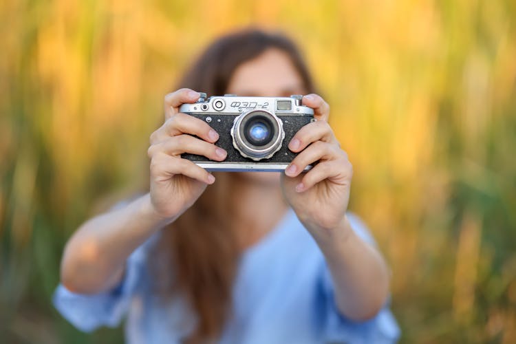 Woman Taking A Photo On A Field