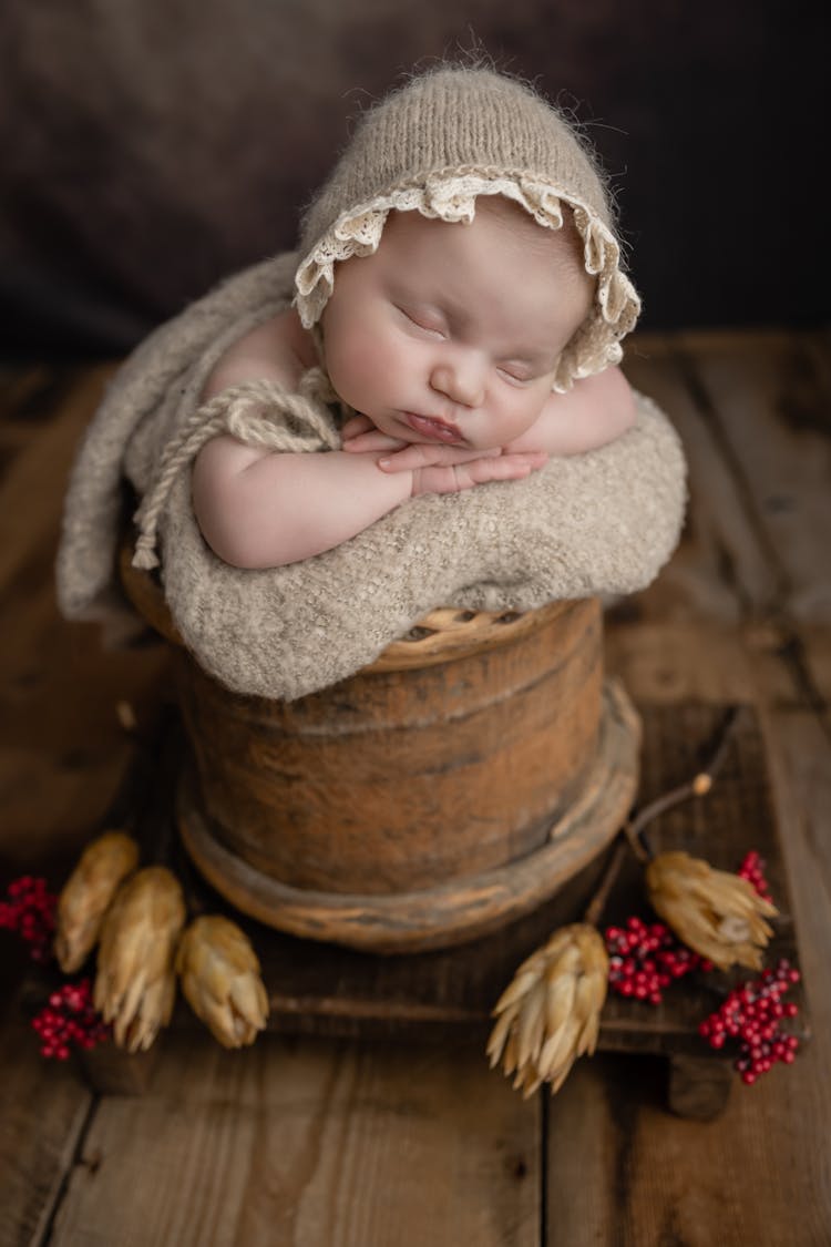 Newborn Asleep In A Wooden Basket