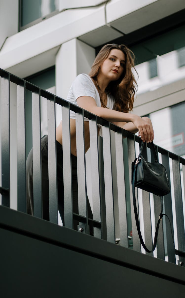 Woman In Tied Crop Top Holding Leather Purse