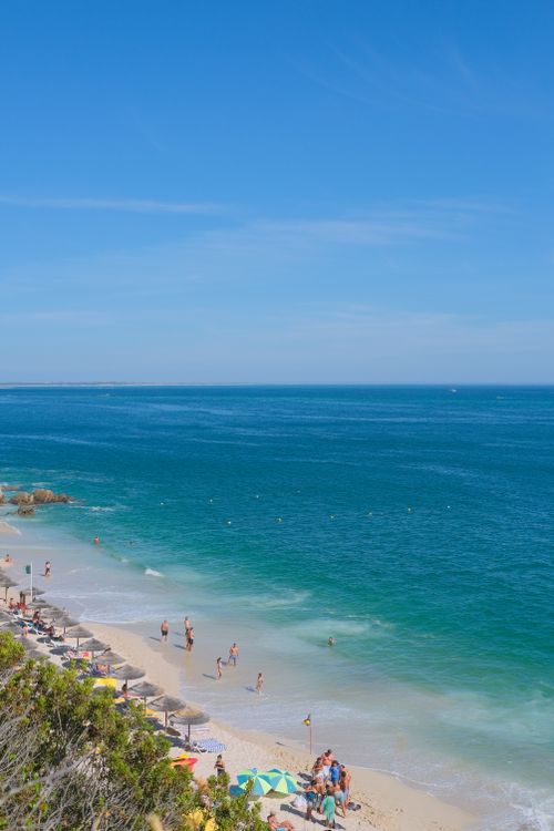 Free Aerial view of the picturesque Portinho da Arrábida beach in Portugal with clear skies and azure waters. Stock Photo