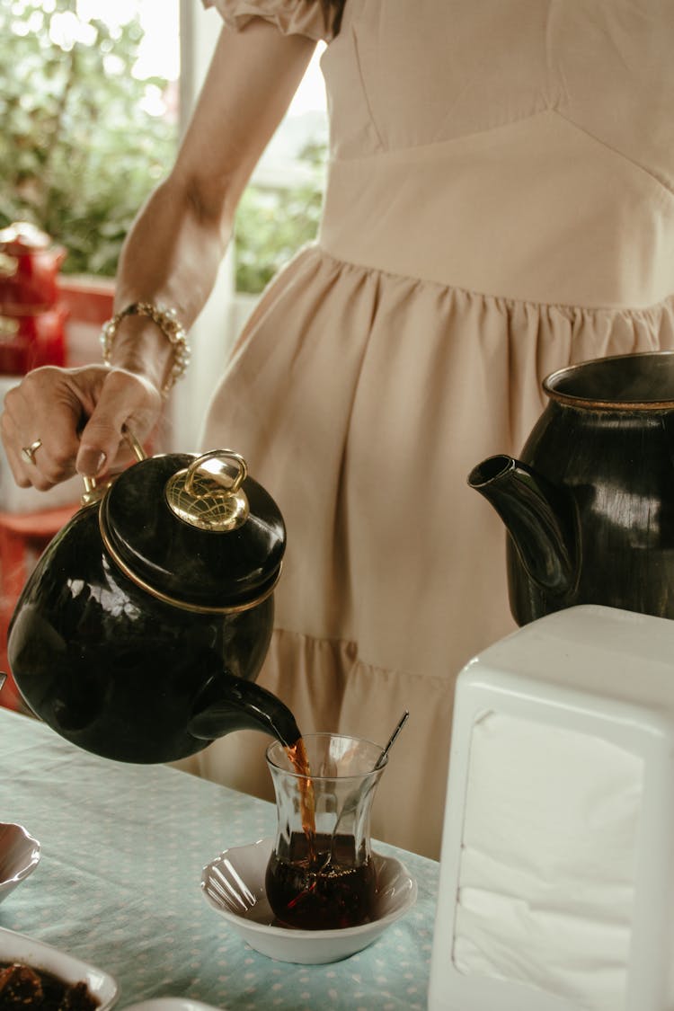 Woman Preparing Coffee In A Kitchen