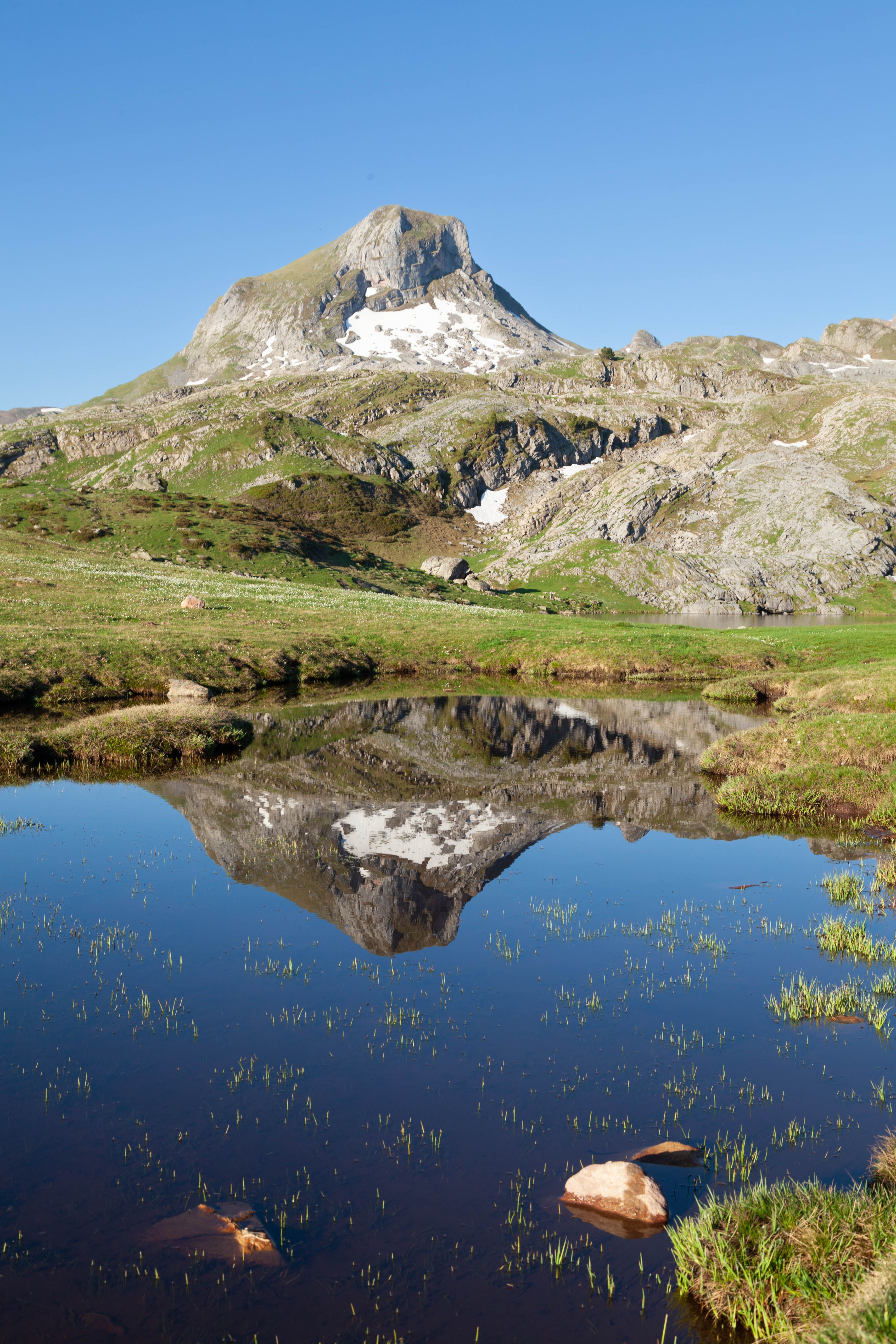 Beautiful mountain landscape of the Pyrenees reflected in a clear lake.
