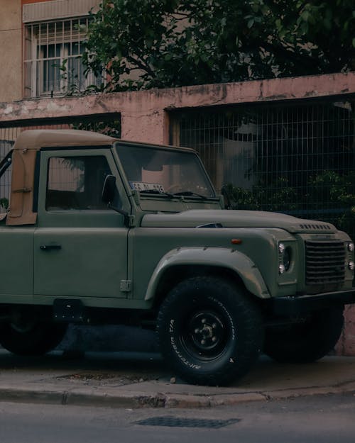 An Old Military Truck Parked on the Street in City 