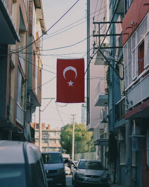 Free Urban street view in Turkey showcasing the national flag prominently hanging overhead. Stock Photo