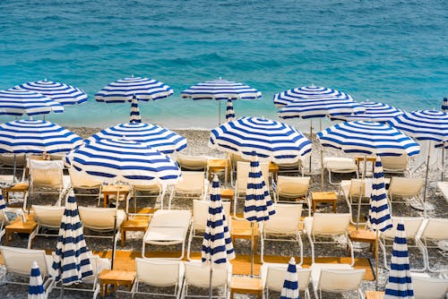 View of Beach Umbrellas and Empty Sun Loungers on a Beach 