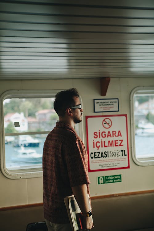 Side View of a Man Standing inside a Ferry 