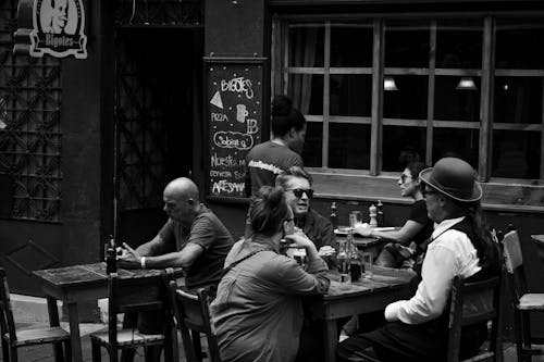 Customers Sitting at Bar Sidewalk Tables