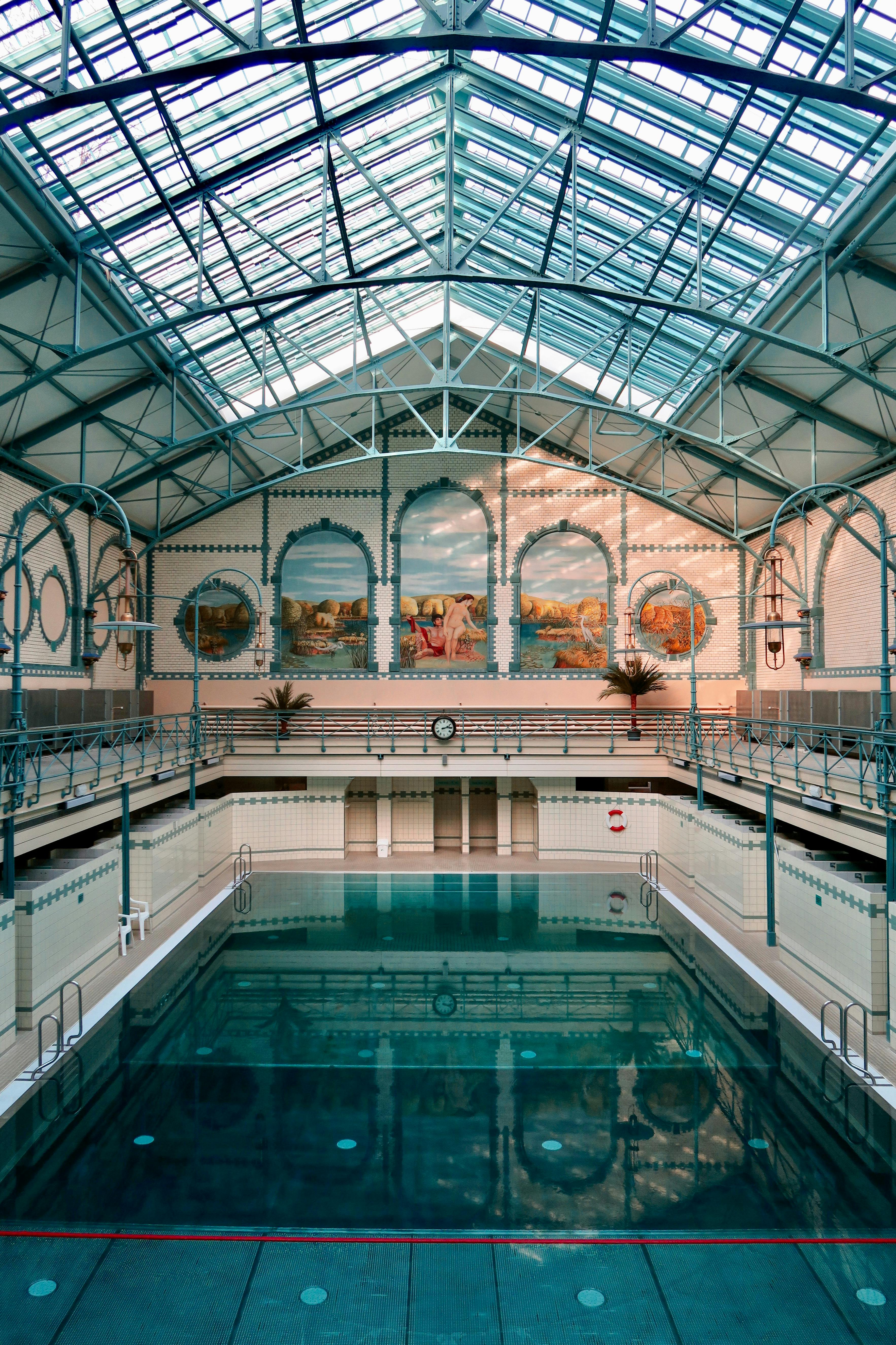 Beautifully detailed interior of Stadtbad Charlottenburg in Berlin with classic architecture and a serene pool.