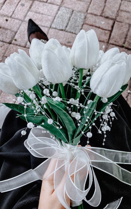 Bouquet of White Tulips in Hands