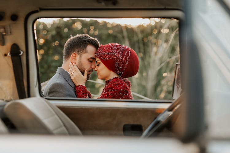 Newlyweds Together Behind Car Window