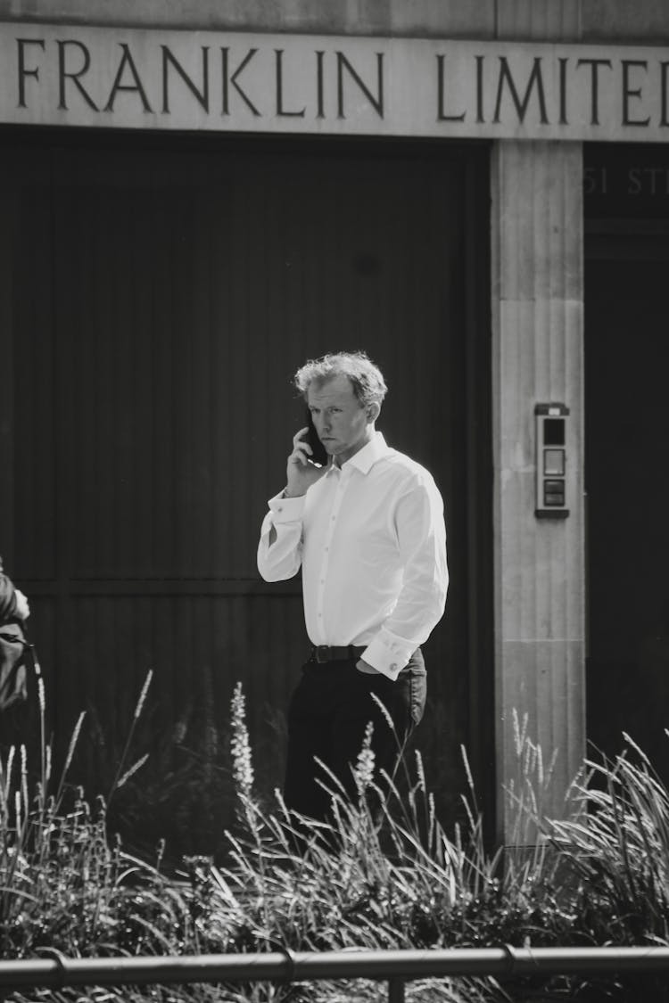 Elegant Man Talking On A Phone In Black And White