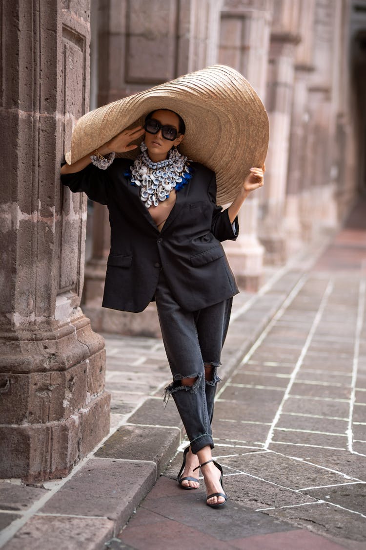 Woman In A Big Hat And Sunglasses