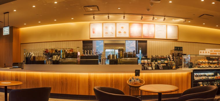 Spacious coffee shop interior with illuminated counter, perfect for a cozy gathering.
