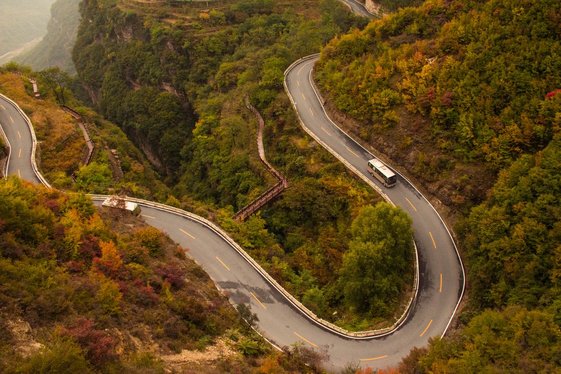 Aerial View of a Curvy Road in Mountains · Free Stock Photo