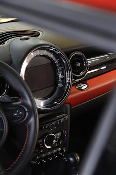 Close-up view of a luxury car dashboard featuring a stylish design with metallic accents and leather textures.
