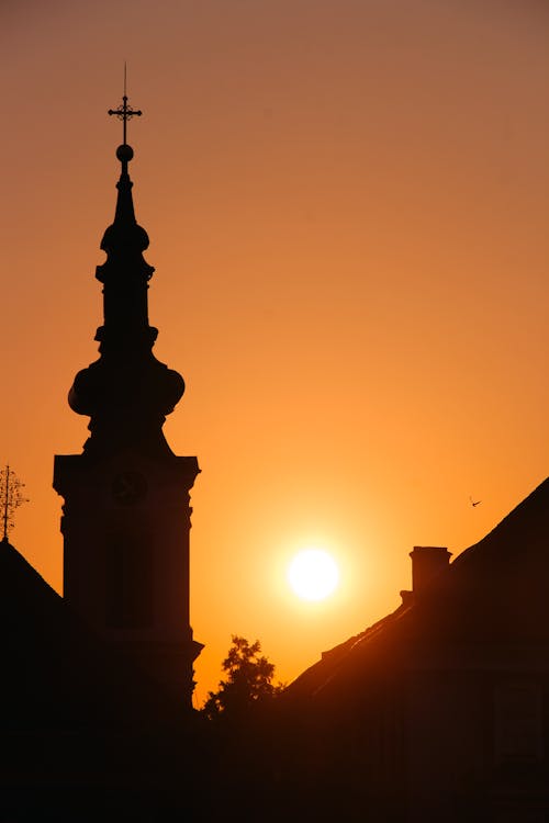 Sun on Yellow Sky over Church Tower