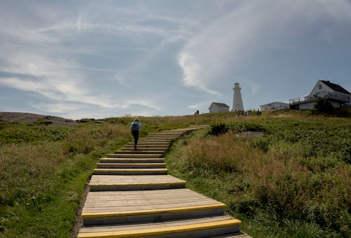 Woman Walking on Stairs in Village