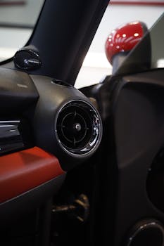 Detailed view of a car's air conditioning vent in a sleek, modern vehicle.