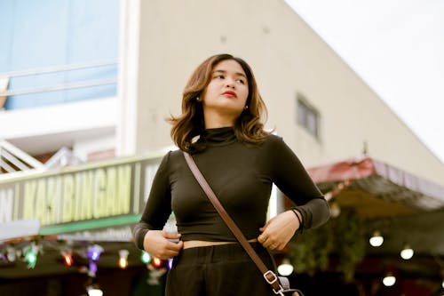 Young Woman Adjusting Cropped Turtleneck