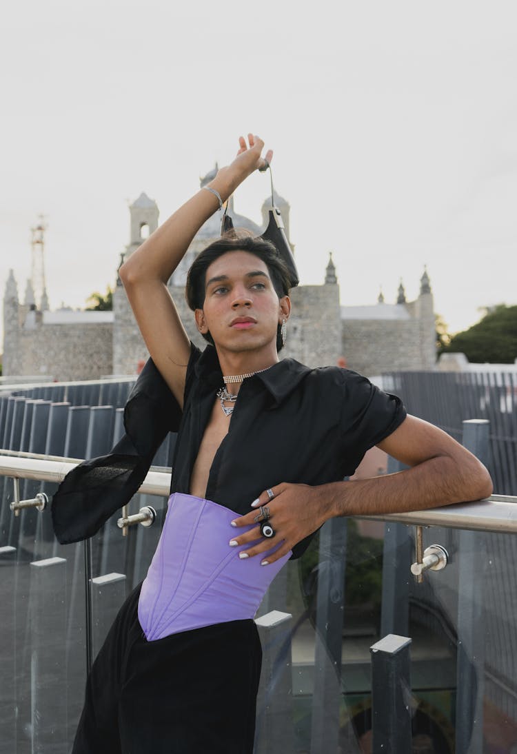 A Man In A Purple Corset And Black Shirt