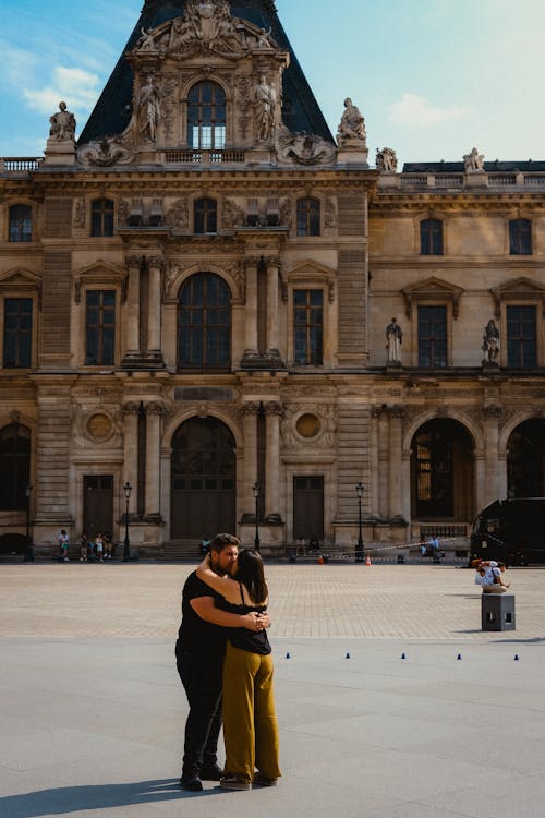 Couple Hugging near Louvre Building in Paris