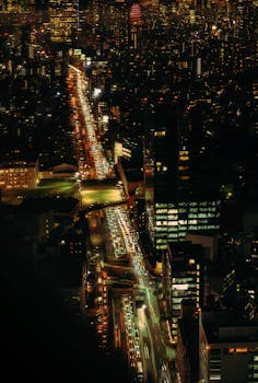 A vibrant cityscape of Shibuya, Tokyo at night with busy streets and illuminated buildings.