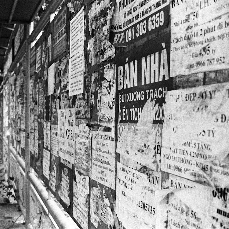 A Wall Covered With Posters And Leaflets 