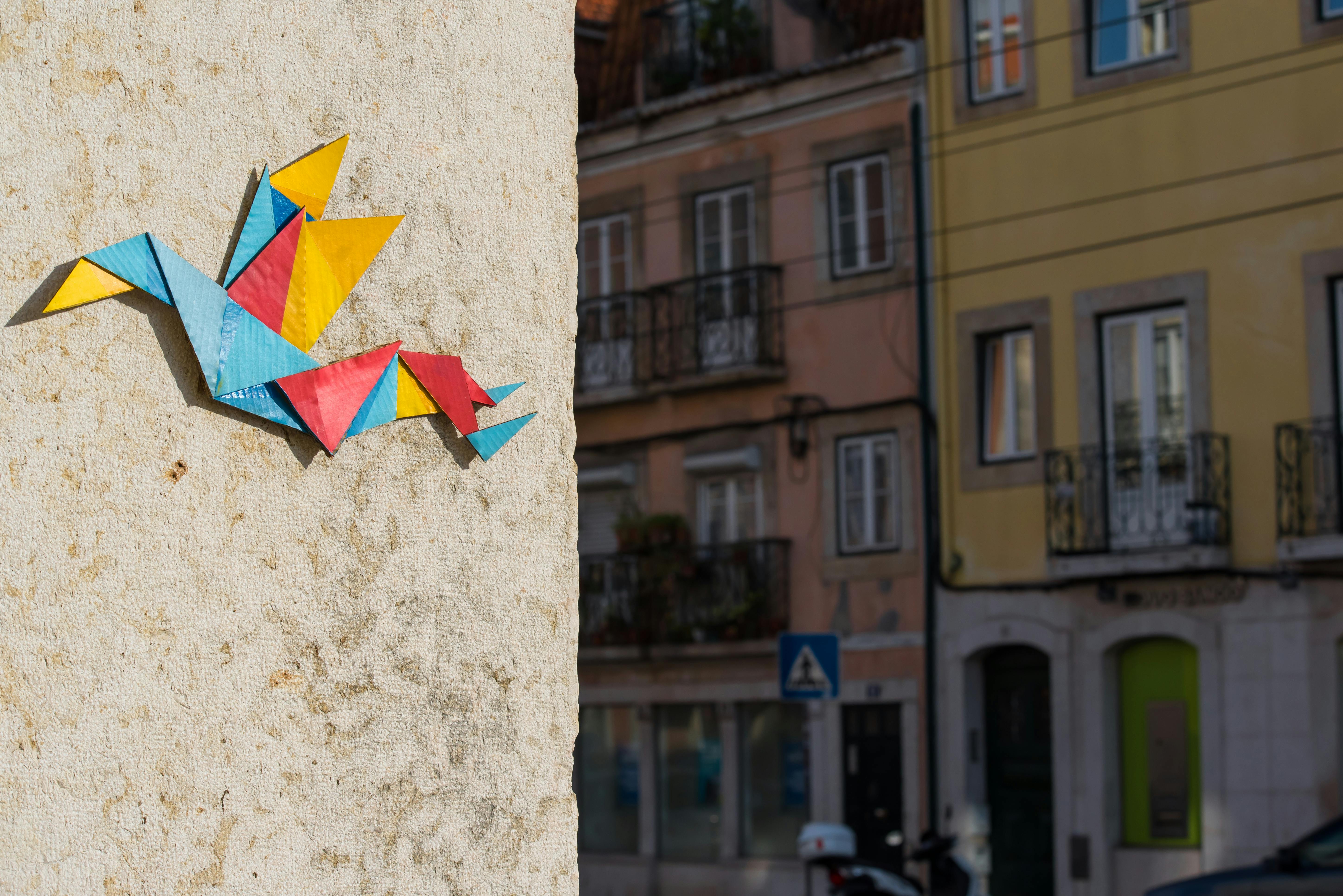 Vibrant origami decoration on an urban wall in Lisbon, Portugal.